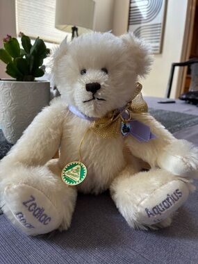 Hermann Lange Cream Plush Bear with Gold Bow and Lavender Ribbon Accents